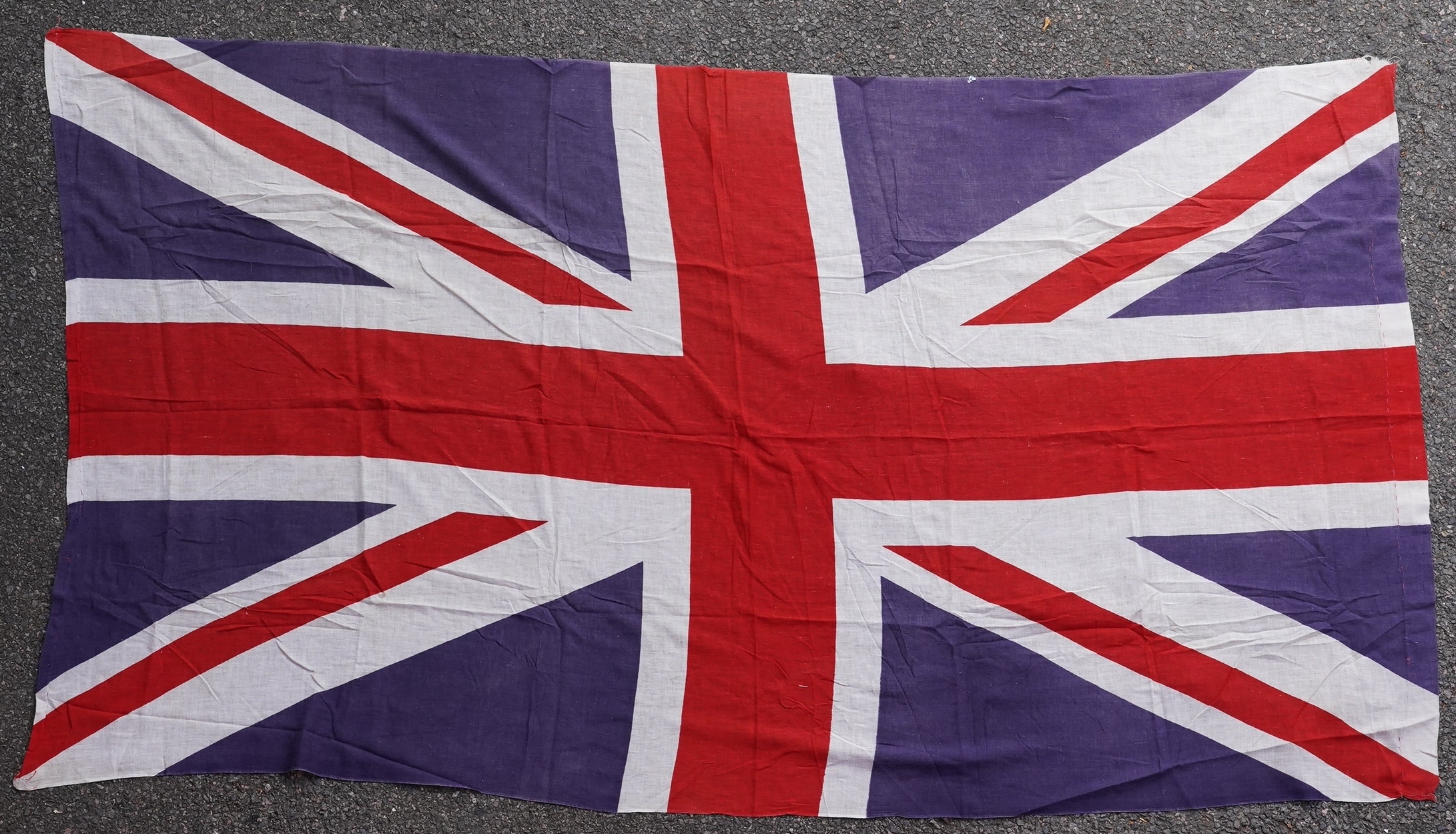 Four flags; two professionally made US Stars and Stripes, both on thick canvas with applied stars and joined stripes, one by the Valley Forge Flag Co., Pennsylvania, stamped “5 x 9.5 ft”, 146 x 288cm and 176 x 300cm, tog